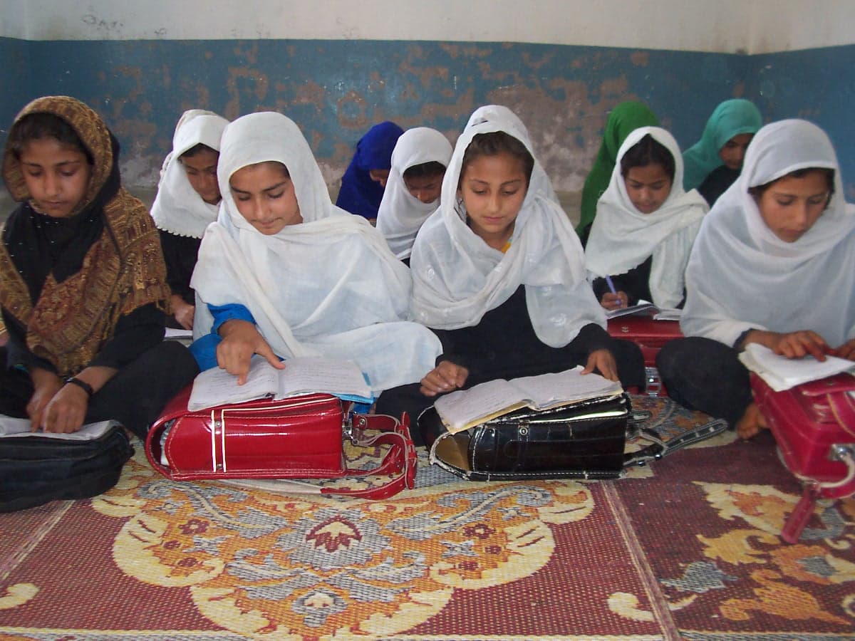 Girls writing and studying in an AWAKEN education program